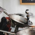 person holding gray cooking pan