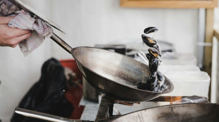 person holding gray cooking pan